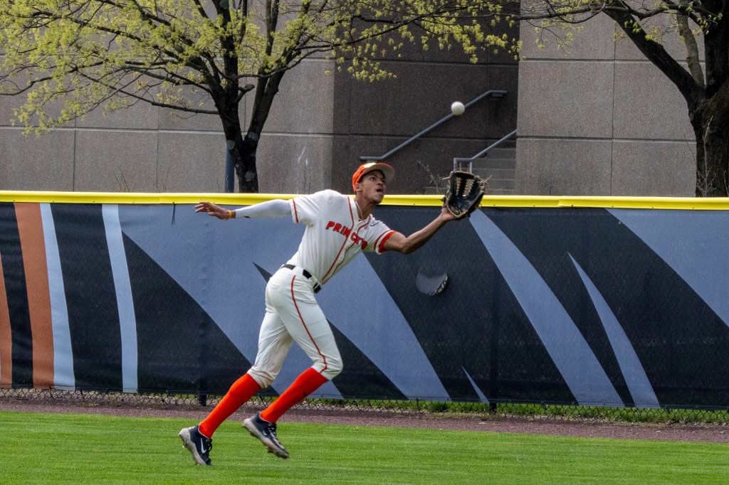 Right fielder Jordan Kelly runs after a ball just above his glove, moments before he hauls it in.