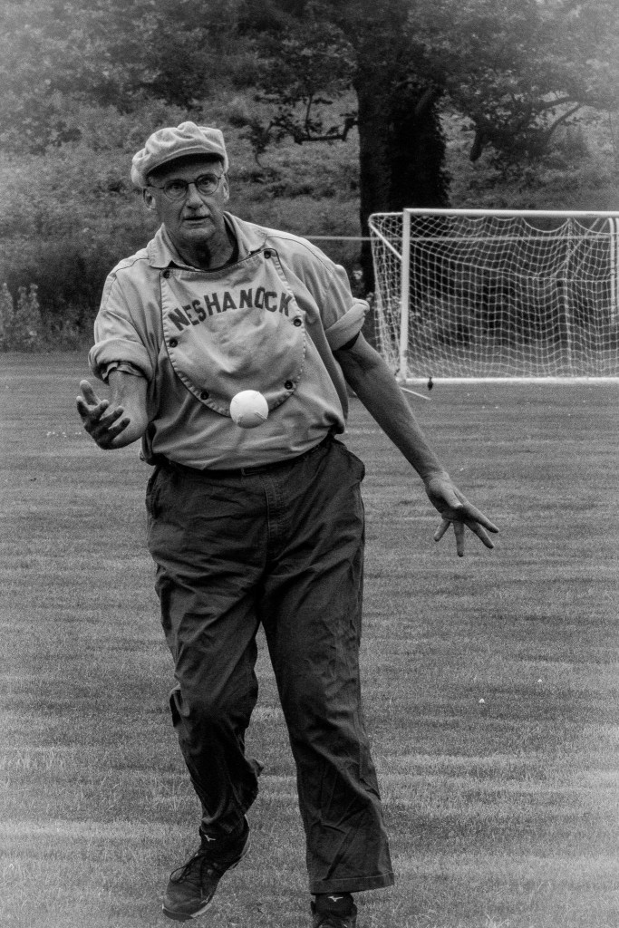 Pitcher lets go of the ball in underhand motion.