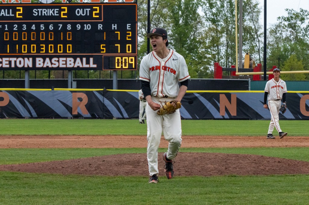 Ethan Shu gives out a yell as he walks off the mound after recording the final out to seal the Princeton victory.