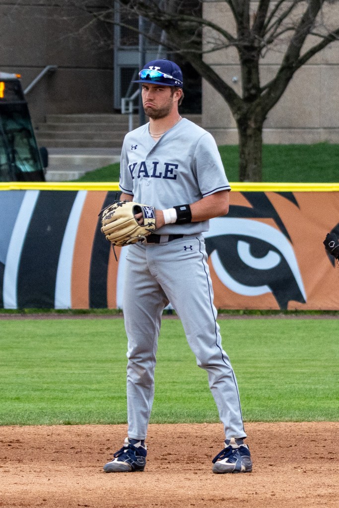 Yale infielder puts on a pouty face while standing in the infield dirt.
