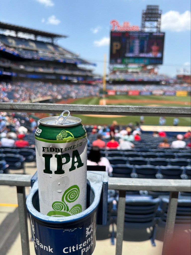 A can of FIddlehead IPA sits in a cupholder on a rail above a walkway in Citizens Bank Park.