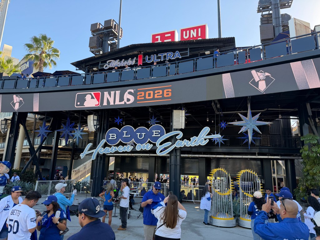 Fans mill about the concourse at the center field entrance to the stadium. 